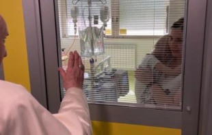 Pope Francis blesses a child in the Department of Pediatric Oncology at the Gemelli Hospital in Rome, July 13, 2021. Vatican Media.